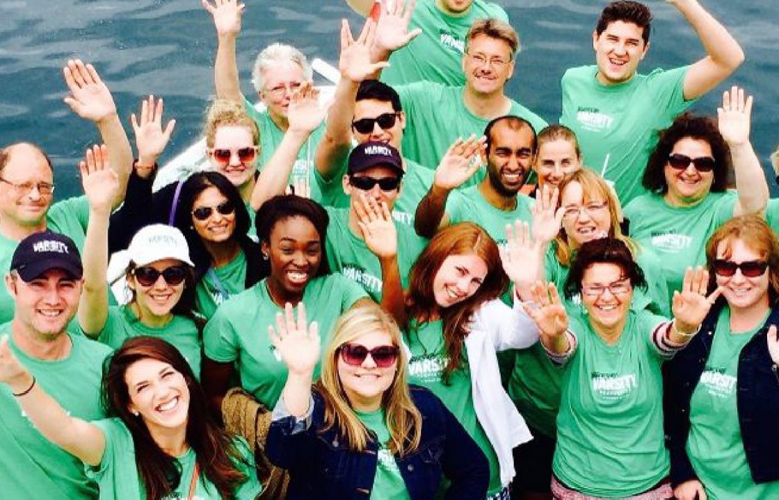 people in green shirts on a boat