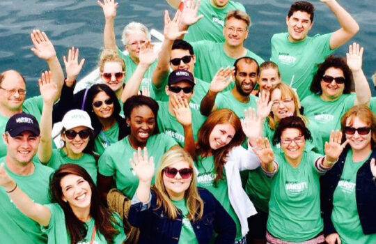 people in green shirts on a boat